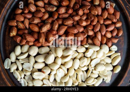 Raw peanuts in a clay bowl. Cajour and shelled beans Stock Photo