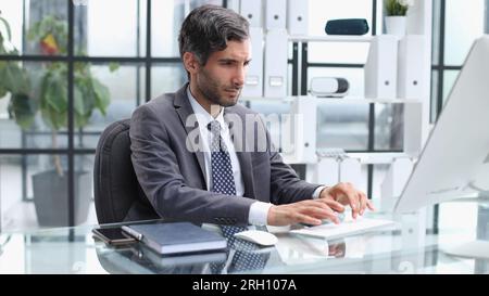 Busy accountant uses notebook PC and has easy access to all e-files in enterprise digital database Stock Photo
