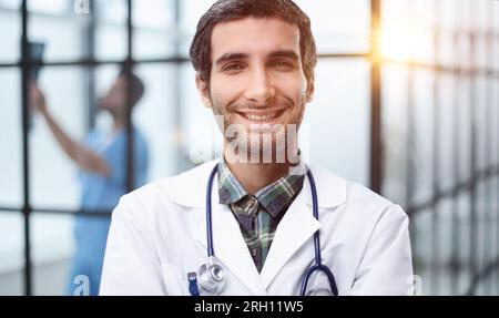 Headshot portrait male doctor or therapist in white medical uniform and stethoscope, Stock Photo