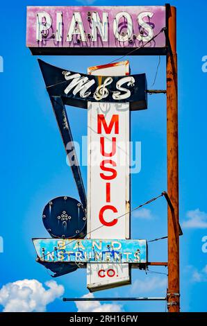 A vintage neon sign advertises pianos and band instruments at M&S Music, Aug. 12, 2023, in Mobile, Alabama. M&S Music opened in 1961. Stock Photo