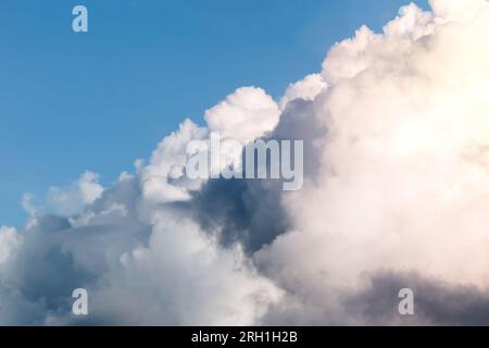 Dark stormy clouds on blue sky background. Stock Photo