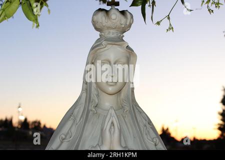 'Divine Serenity-A captivating marble statue of a woman in prayer, evoking a profound sense of peace and spiritual contemplation.' Stock Photo