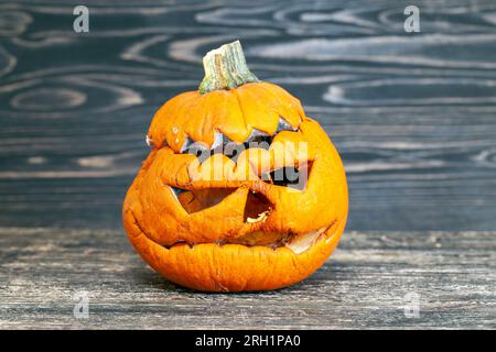 rotting pumpkin head for halloween, carved from pumpkin frightening face in mold and mildew during decomposition Stock Photo