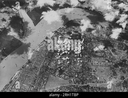 Burma Campaign, 1941-1945. An aerial reconnaissance photo shows the capital of Burma, Rangoon, under intense bombing during an air raid from the Imperial Japanese Army Air Service. Japanese air raids were conducted on Rangoon from December 1941 until the fall of the city to Japanese forces in March 1942. Stock Photo