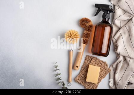 Eco-friendly amber soap bottle and wooden dish brushes. Sustainable homecare concept. Stock Photo