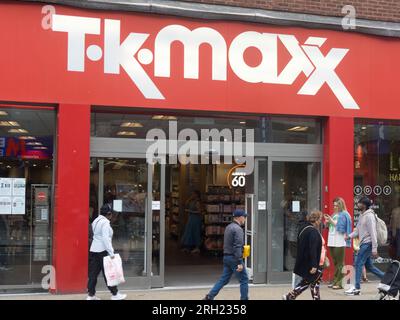 Busy TK Maxx retail clothing business shoppers & red shop front in