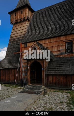 Small southern porch on Gothic wooden church at Dębno Podhalańskie, Poland, and western tower with projecting bell chamber, typical of the area. Stock Photo