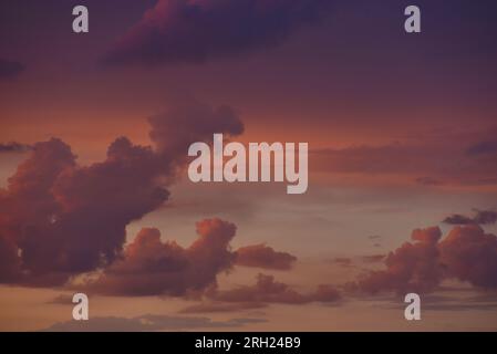 Pink clouds and evening sunset sky after a thunderstorm. Blue-red sunset evening. Beautiful pink clouds. Stock Photo