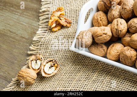 Walnuts on a white tray over natural background. Horizontal shot. Stock Photo