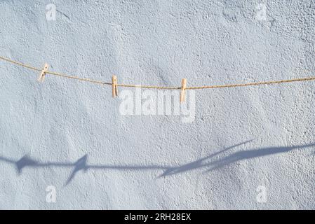 Wooden clothespins on the rope. Stock Photo