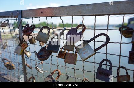 Love padlocks. Padlocks connected to the fence on the bridge. Stock Photo
