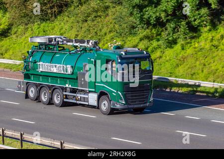 2023 VOLVO FH  Globetrotter XL tractor units rear steer axle dump trucks with lifting axle. Collection of liquid waste vacuum truck, travelling on the M6 motorway in Greater Manchester, UK Stock Photo