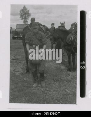 SS Photographer, Fritsch, Romania, Kavallerie, Russia 1943-44 Romanian honour guard, Romanian soldiers undergoing health physicals,  officers with Romanian officials and officers, farm scenes, villagers in traditional dress, recruiting activities, formal ceremony, individual portrait and group photos, soldiers field training, sports activities, officials in radio studio, local performers and cultural activities, soldiers in field with horses, assault guns, motorcycles, and signal equipment, burning village.  Images depicting the front-line activities of Waffen-SS units on the Western and Easte Stock Photo