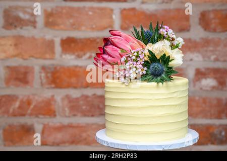 Wedding cake fresh flowers isolated Stock Photo