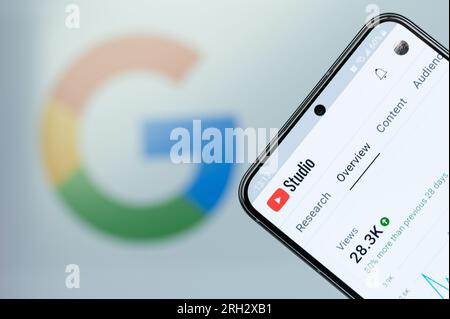 New York, USA - August 6, 2023: Open Youtube studio app on smartphone screen close up with blurred logo background Stock Photo