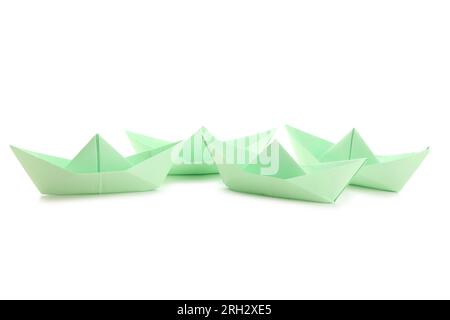 Green origami boats on white background Stock Photo