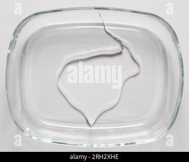 Broken glass dish with crack isolated on white studio background Stock Photo