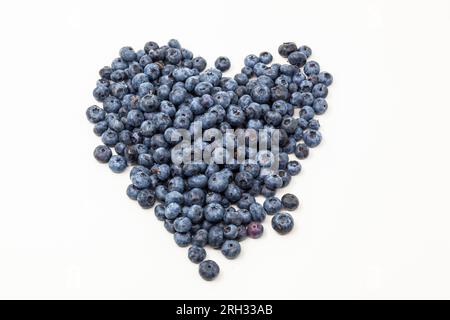 A heart of blueberries in different sizes on a white background. Horizontal. Photo in high quality. Stock Photo