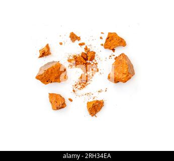 Flying pieces and powder of broken red brick isolated on white Stock Photo