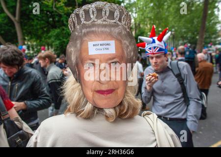 Anti-monarchy demonstrator wearing Queen mask protests during Royal weeding day celebrations. London, UK Stock Photo
