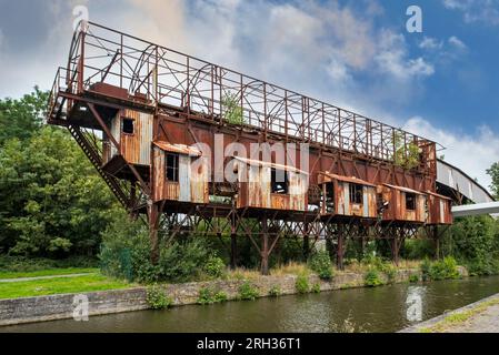 Old shiploader / boat loader for loading porphyry gravel from quarry onto riverboats on the Vaudémont Canal, Lessines, Hainaut, Wallonia, Belgium Stock Photo