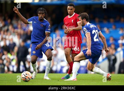 Liverpool's Trent Alexander-Arnold (centre) battles for the ball with Chelsea's Carney Chukwuemeka (left) and Ben Chilwell during the Premier League match at Stamford Bridge, London. Picture date: Sunday August 13, 2023. Stock Photo