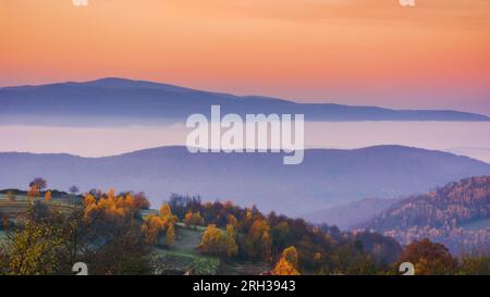 carpathian mountain landscape in autumn. beautiful countryside scenery. foggy sunrise Stock Photo