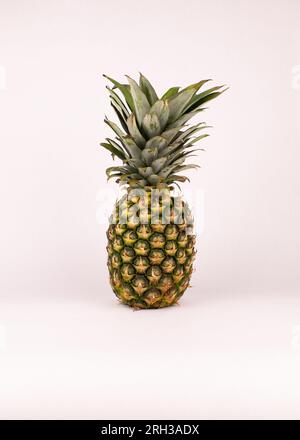 Uncut tasty ripe pineapple white background Stock Photo