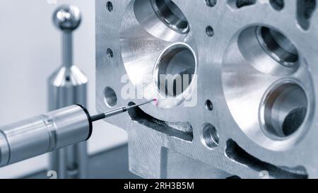 Quality control on milling CNC machine, coordinate measuring machine, Quality control machine. cylinder block of diesel engine repair. Stock Photo