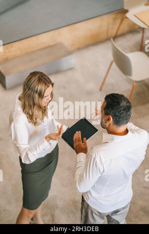 Two middle-aged business company leaders discussing new big deal. Above view shot Stock Photo