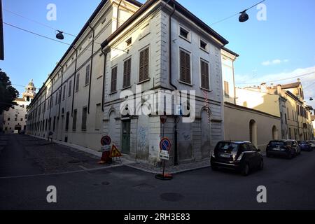 Corner  of a building at the crossroad of two street in an italian town at sunset Stock Photo