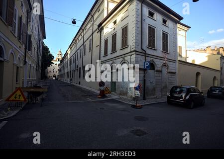 Corner  of a building at the crossroad of two street in an italian town at sunset Stock Photo