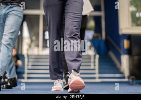 Cropped photo of students going home after college, low angle Stock Photo