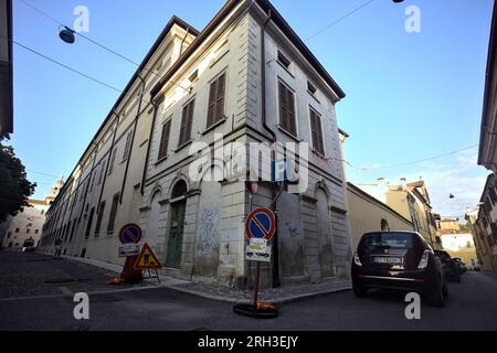 Corner  of a building at the crossroad of two street in an italian town at sunset Stock Photo