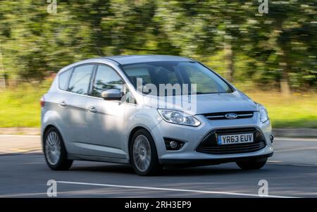 Milton Keynes,UK - Aug 10th 2023:2013  Silver diesel engine Ford C-Max car driving on an English country road. Stock Photo