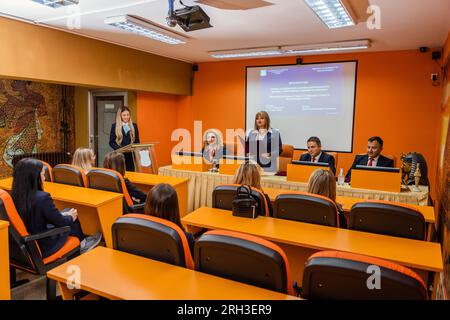 Group of students and professors getting ready to hear their student present a project Stock Photo