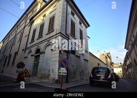 Corner  of a building at the crossroad of two street in an italian town at sunset Stock Photo