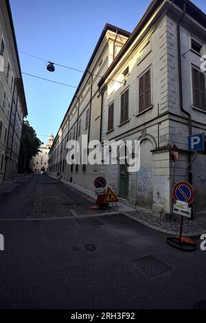 Corner  of a building at the crossroad of two street in an italian town at sunset Stock Photo