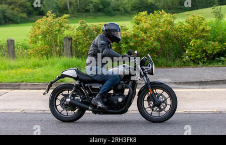 Milton Keynes,UK - Aug 13th 2023: 2017 Triumph Street Cup motorcycle driving on an English country road. Stock Photo