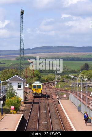Track Signal Machine Railway track tamping machine passing the mechanical signal box and ...
