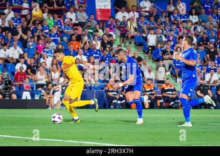 Getafe, Madrid, Spain. 13th Aug, 2023. Raphinha (Barcelona) and Fabrizio German Angileri (Getafe) in action during the LaLiga EA Sports football match between Getafe and Barcelona played at Coliseum Alfonso Perez Stadium on August 13, 2023 in Getafe, Spain (Credit Image: © Alberto Gardin/ZUMA Press Wire) EDITORIAL USAGE ONLY! Not for Commercial USAGE! Credit: ZUMA Press, Inc./Alamy Live News Stock Photo