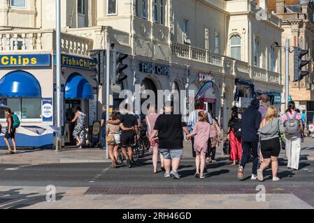 Weston Super Mare, Somerset, England, UK. 25 June 2023. Holidaymakers crossing the road on the beachfront toward the town centre, Weston. Stock Photo