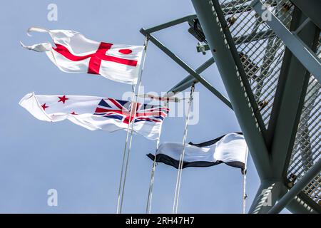 Flags flying onboard HMNZS Canterbury whilst taking part in an International Maritime Exercise in the Hauraki Gulf, Auckland, New Zealand Stock Photo