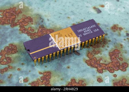 KYIV, UKRAINE - August 2, 2023. Intel 287 floating-point unit coprocessor unit on rusty background. Stock Photo