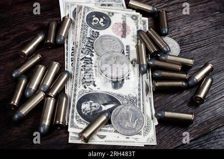 Old west period US banknotes and silver certificates with silver dollar coins and .45 caliber revolver ammunitions background Stock Photo