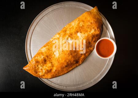 Stromboli with marinara sauce Stock Photo