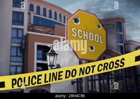 Yellow crime scene tape blocking way to school Stock Photo