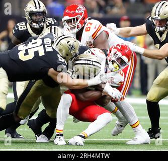 New Orleans, USA. 13th Aug, 2023. New Orleans Saints defensive tackle Jack Heflin (95) and linebacker Anfernee Orji (58) tackles Kansas City Chiefs running back La'Mical Perine (29) during a National Football League preseason game at the Caesars Superdome in New Orleans, Louisiana on Sunday, August 13, 2023. (Photo by Peter G. Forest/Sipa USA) Credit: Sipa USA/Alamy Live News Stock Photo