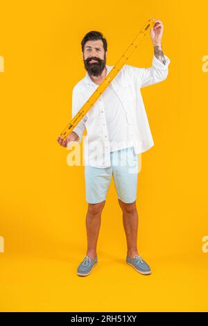 confused school man measure with ruler isolated on yellow. school man ...
