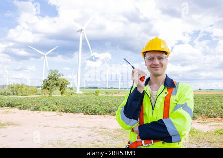 Portrait happy smiling engineer professional techician male working in wind turbines service location site Stock Photo
